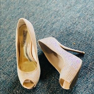 Cream colored peep toe heels with rhinestones all over.